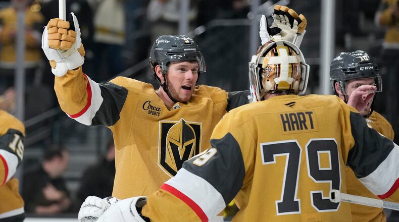Vegas Golden Knights defenseman Jeremy Lauzon, left, celebrates with Vegas Golden Knights goaltender Carter Hart (79) after defeating the Utah Mammoth in Game 1 of a first-round NHL hockey Stanley Cup playoff series Sunday, April 19, 2026, in Las Vegas. (AP Photo/John Locher)