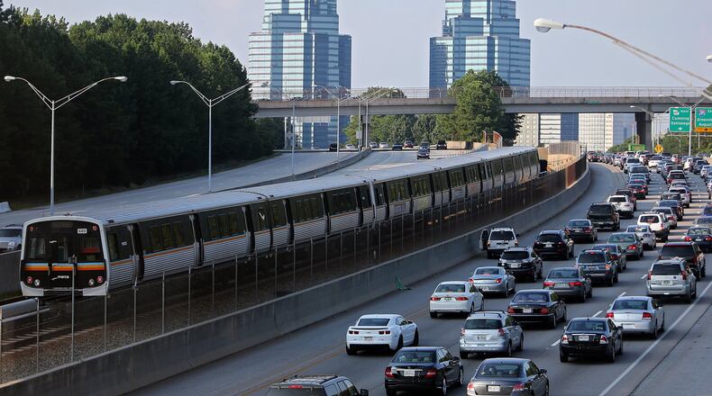 August 29, 2013 Sandy Springs: A MARTA train makes its way North past Ga. 400 traffic on Thursday afternoon August 29, 2013. BEN GRAY / BGRAY@AJC.COM