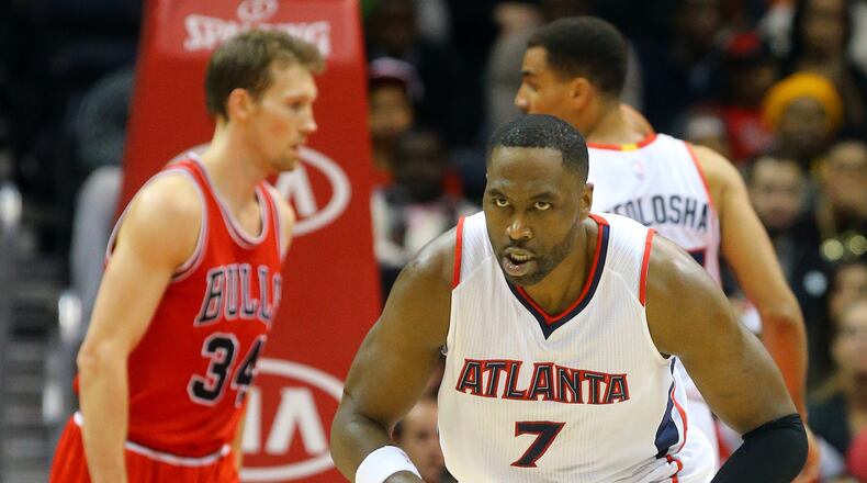 Hawks forward Elton Brand reacts to making a shot against Bulls guard Mike Dunleavy in the final minutes Monday, Dec. 15, 2014, in Atlanta. The Hawks beat the Bulls 93-86.