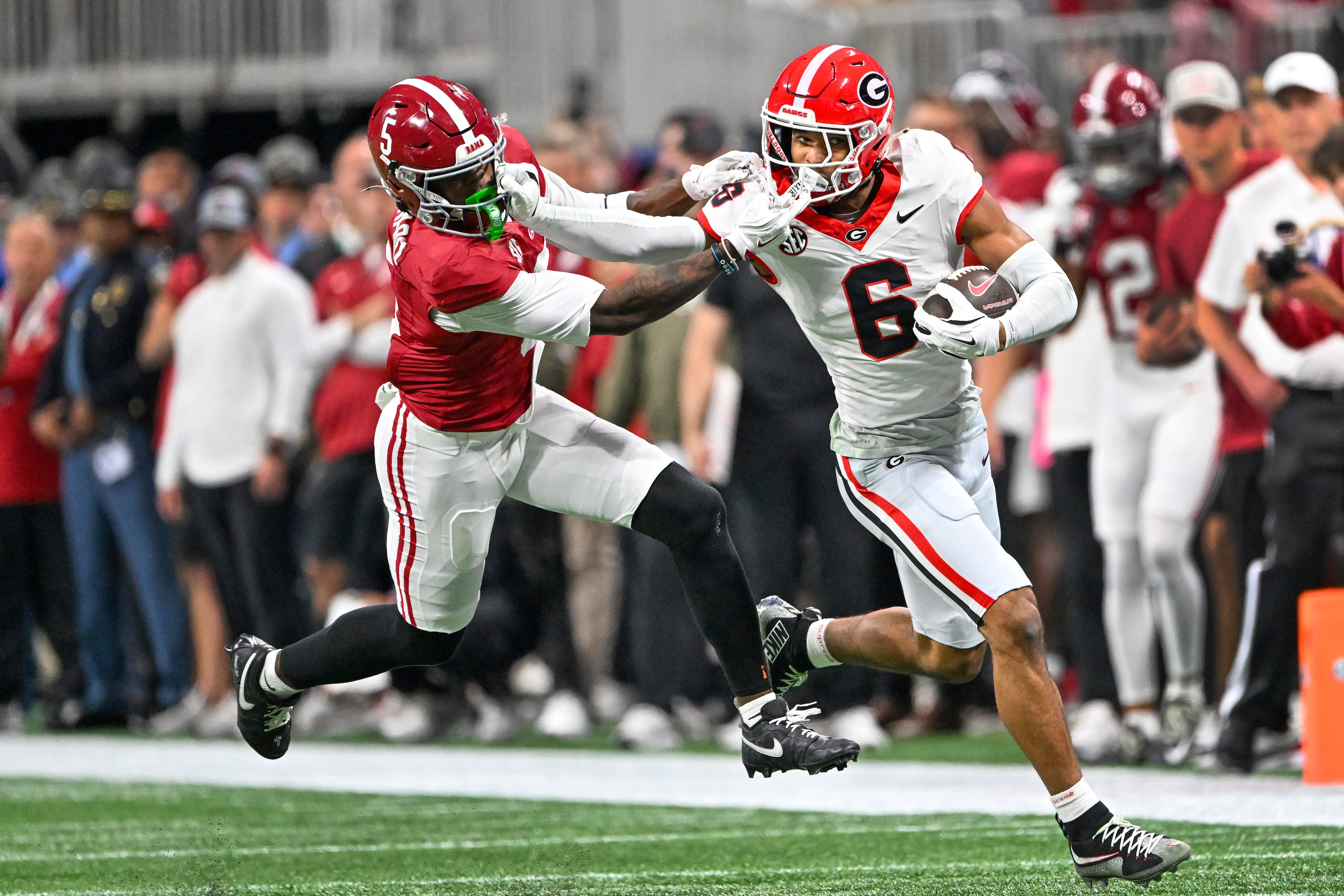 Georgia defensive back Daylen Everette (6) intercepts the ball from Alabama quarterback Ty Simpson and fends off wide receiver Germie Bernard (5) during the first half of the SEC Championship game at Mercedes-Benz Stadium, Saturday, Dec. 6, 2025, in Atlanta. (Hyosub Shin / AJC)