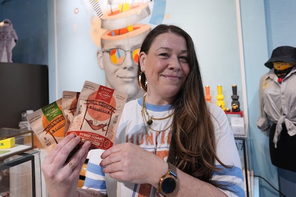 Employee Savannah Gavlik displays THC products at the Dope Daughters dispensary that Texas lawmakers are seeking to ban, Thursday, May 29, 2025, in Austin, Texas. (AP Photo/Eric Gay)