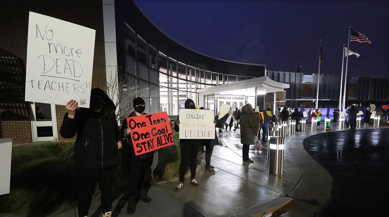 Hundreds of Cobb County teachers and staff hold a protest in the parking lot during the school board meeting at the Cobb County School District's Offices on Thursday. Cobb teachers are pressing the district for improved COVID-19 response.  Curtis Compton / Curtis.Compton@ajc.com”