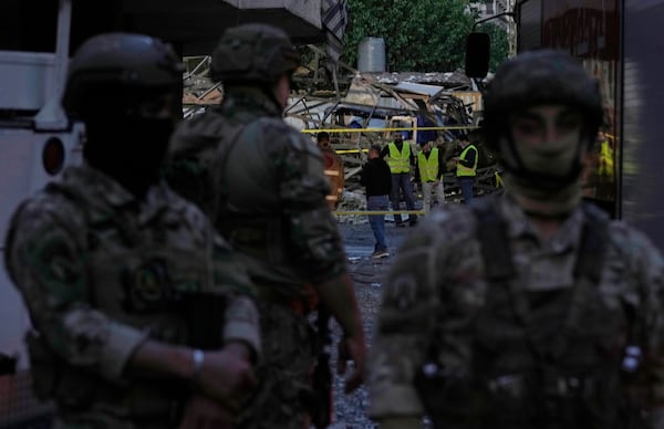 Civil defence workers and Lebanese soldiers gather at the site of an Israeli airstrike in Dahiyeh in the southern suburb of Beirut, Lebanon, Sunday, April 27, 2025. (AP Photo/Bilal Hussein)