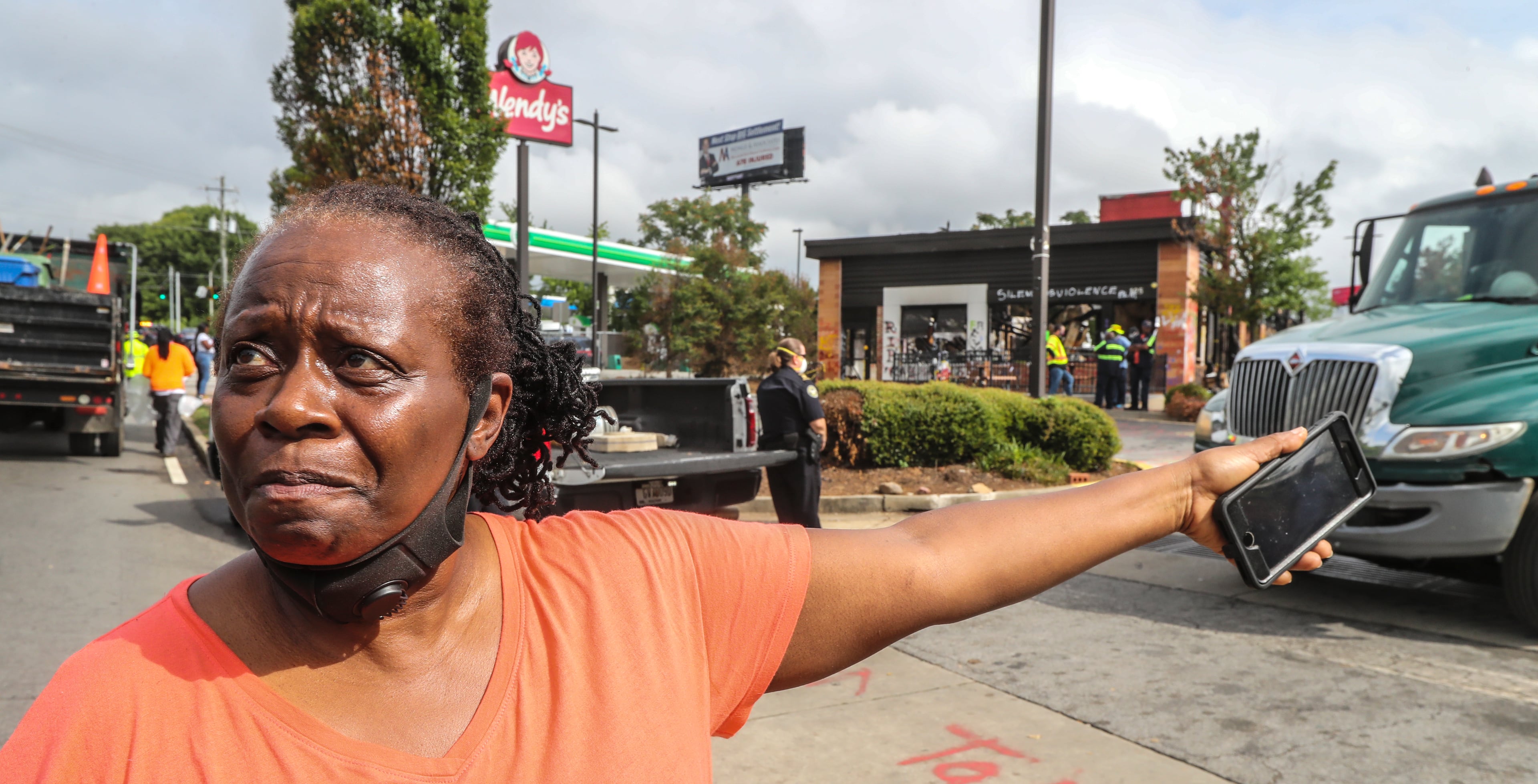 Atlanta City Councilperson, Joyce Sheperd was on the scene where Atlanta police and sanitation crews finished removing protesters and their belongings from outside the Wendy’s on Monday July 6, 2020 where Rayshard Brooks was shot and killed by an officer last month. The last concrete barricade was put in place around noon. Some of the protesters milled nearby while a worker from the BP gas station next door pulled boards off the windows. Monday’s cleanup followed a violent holiday weekend that started Saturday night when 8-year-old Secoriea Turner was fatally shot while sitting in a car near the restaurant. Atlanta Mayor Keisha Lance Bottoms denounced the violence in an emotional press conference at police headquarters in which she and Turner’s family urged people to come forward with information about the girl’s killers. About 9:30 a.m. Monday, uniformed officers and multiple workers in neon attire tossed flowers and other items from a makeshift memorial outside the Wendy’s into garbage bags. The site has served as ground zero for protests since Brooks was shot in the parking lot following an attempted DUI arrest in the drive-thru line June 12. The restaurant was destroyed during a large protest the next day. Three people have been arrested on arson charges in connection with the incident. (John Spink/AJC)