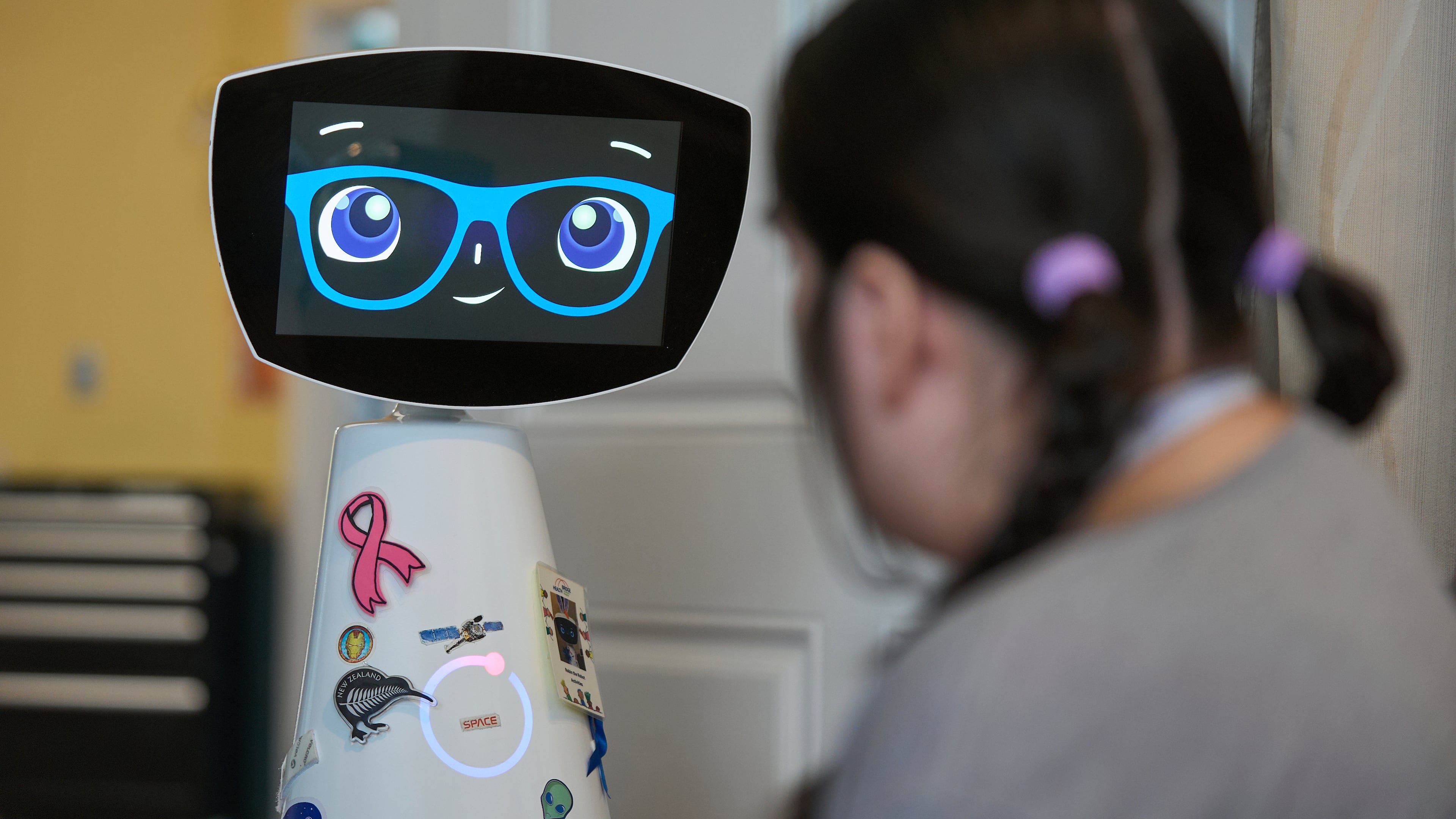 Robin the Robot visits with a patient at the HealthBridge Orange Specialty Pediatric Hospital in Orange, Calif., on Friday, Sept. 12, 2025. (AP Photo/Damian Dovarganes)