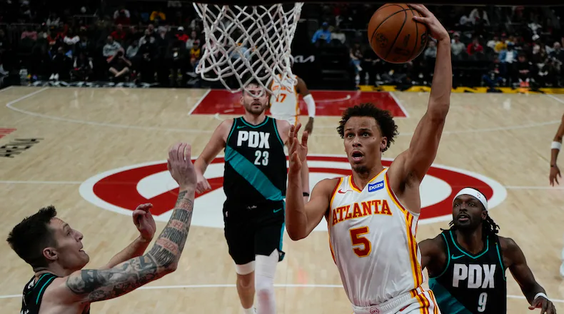 Atlanta Hawks guard Dyson Daniels (5) shoots against Portland Trail Blazers guard Vit Krejci (27) during the first half of an NBA basketball game, Sunday, March 1, 2026, in Atlanta. (AP Photo/Mike Stewart)