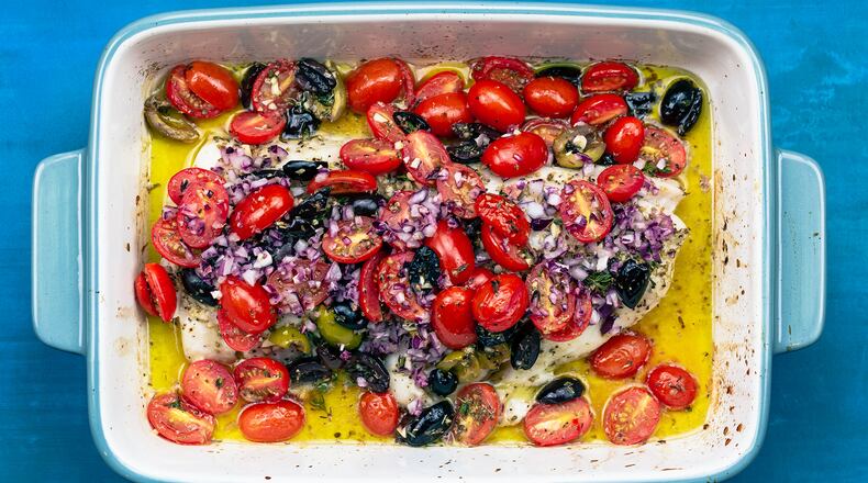 Suzy Karadsheh's baked white fish is seasoned with oregano and garlic, and topped with a mixture of tomatoes, olives and red onions. Courtesy of Suzy Karadsheh and the Mediterranean Dish