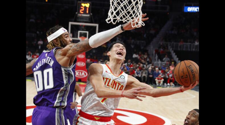Atlanta Hawks guard Jeremy Lin (7) scores against Sacramento Kings center Willie Cauley-Stein (00) during the first half of an NBA basketball game Thursday, Nov. 1, 2018, in Atlanta. (AP Photo/John Bazemore)