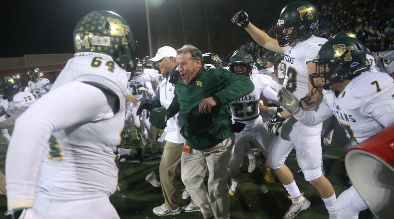 Blessed Trinity coach Tim McFarlin celebrates with players after he got dunked with gatorade after their win against Marist during the Class AAAA Championship game at Marist School Friday, December 15, 2017, in Atlanta. Blessed Trinity won 16-7. PHOTO / JASON GETZ
