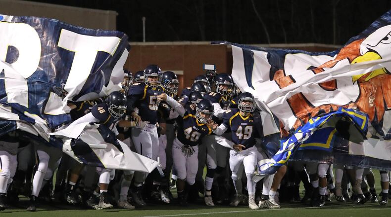 Marist players run onto the field before their game against Blessed Trinity during the Class AAAA Championship game at Marist School Friday, December 15, 2017, in Atlanta.