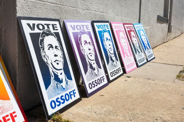 A series of posters in support of U.S. Sen. Jon Ossoff are seen outside the Georgia Theatre in Athens on Sunday. (Felix Scheyer for the AJC)