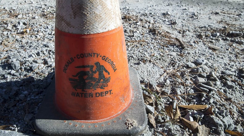 A DeKalb County Department of Watershed Management traffic cone is placed along the construction site where a water issue caused a brief outage on Mt. Olive Drive in Decatur on Jan. 11, 2019. (ALYSSA POINTER/ALYSSA.POINTER@AJC.COM)