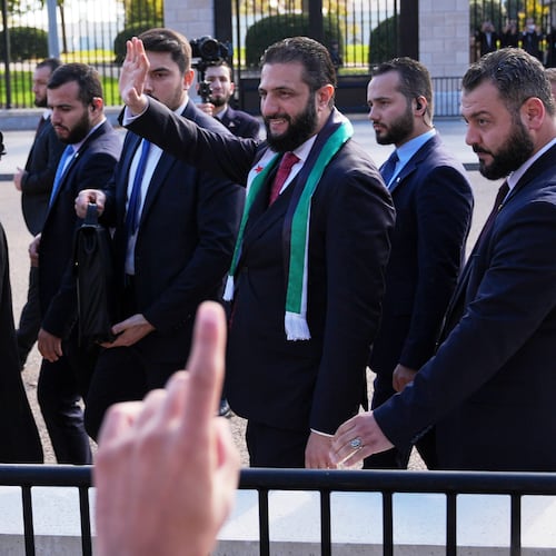 Syria's President Ahmed al-Sharaa waves as he greets supporters outside of the White House, Monday, Nov. 10, 2025, in Washington, following a meeting with President Donald Trump. (AP Photo/Jacquelyn Martin)
