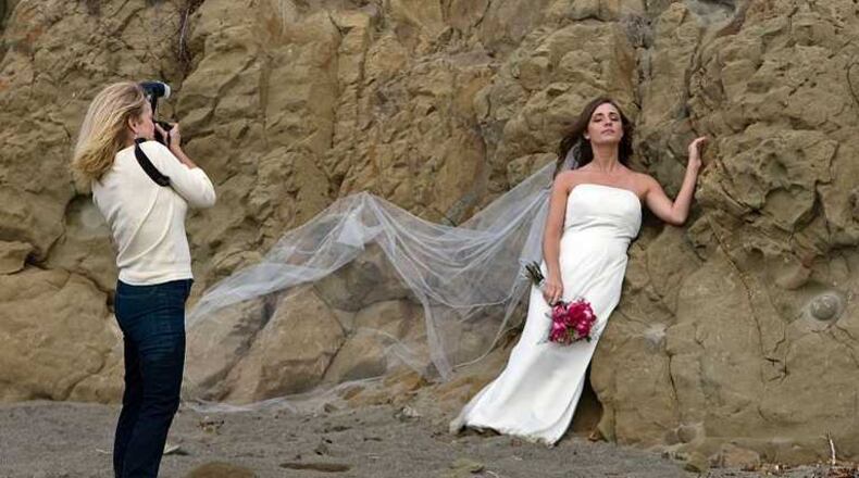 A photographer and bride during photo shoot. Source: Wikimedia commons. Author: Michael L. Baird