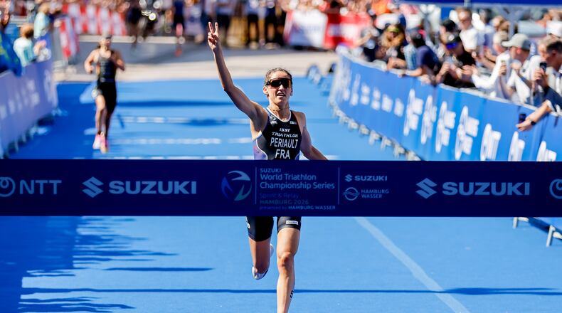 France's Leonie Periault celebrates winning the woman's ITU World Triathlon Series/World Championship race in Hamburg, Germany, Saturday, July 11, 2026. (Philipp Szyza/dpa via AP)