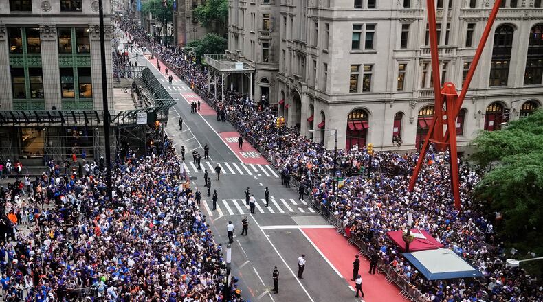 Crowds fill the sidewalks waiting for the start of the NBA Champion New York Knicks taker-tape parade on Broadway, in New York's "Canyon of Heroes," Thursday, June 18, 2026. (AP Photo/Richard Drew)