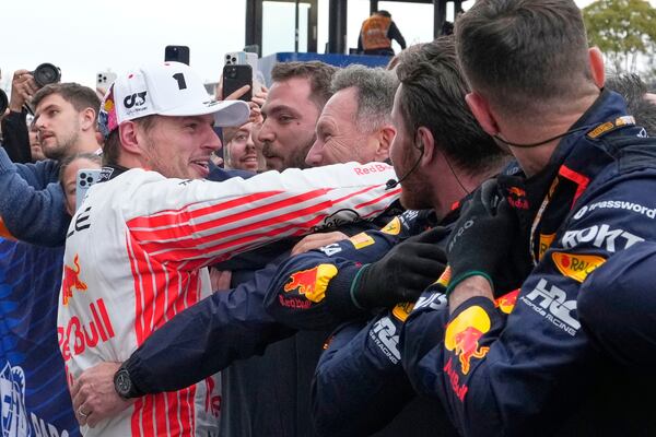 Red Bull driver Max Verstappen of the Netherlands, left, celebrates with Red Bull team principal Christian Horner, right, after winning the Japanese Formula One Grand Prix race at the Suzuka Circuit in Suzuka, central Japan, Sunday, April 6, 2025. (AP Photo/Shuji Kajiyama, Pool)