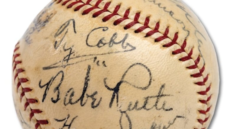 A baseball containing signatures of 11 Hall of Famers -- including Ty Cobb, Babe Ruth and Honus Wagner -- sold for more than $623,000 Sunday.