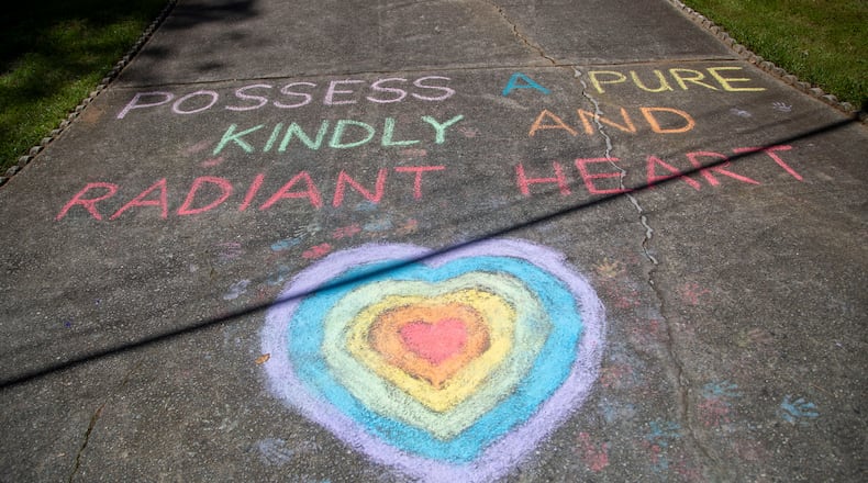 05/01/2020 - Duluth, Georgia  - "Poses a pure, kindly and radiant heart," reads the message that Berkeley Lake Elementary School science specialist instructor Kathy Benltey drew at the end of her driveway  in Duluth, Friday, May 1, 2020. Bentley received help with creating the heart from students who live in her neighborhood. (ALYSSA POINTER / ALYSSA.POINTER@AJC.COM)