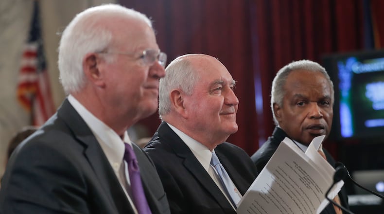 Former Georgia Gov. Sonny Perdue, center, accompanied by former Georgia senator Saxby Chambliss, R-Ga., left, and U.S. Rep. David Scott, D-Atlanta, prepares to testify on Capitol Hill in Washington on Thursday. AP Photo/Pablo Martinez Monsivais