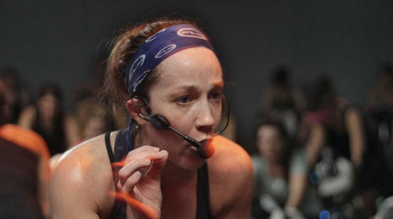 Instructor Kate Hickl leads the class on a 45 minute workout in near total darkness. Flywheel Stadium Cycling is a new indoor cycling gym in Atlanta. Sessions are held in the dark, led by an instructor.