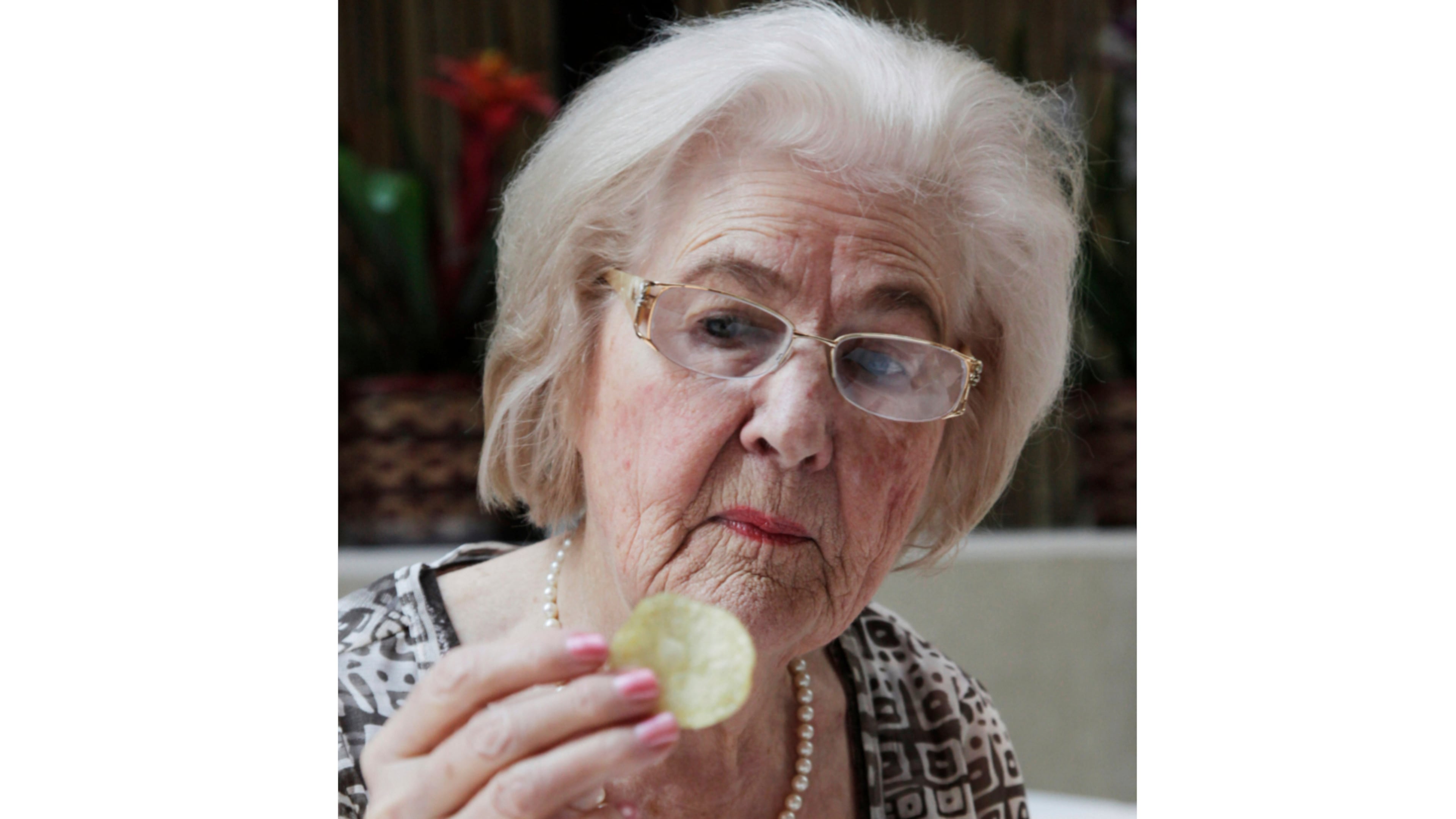 FILE - Marilyn Hagerty samples a Lays potato chip during an interview with The Associated Press, on March 14, 2012, in New York. (AP Photo/Mark Lennihan, File)