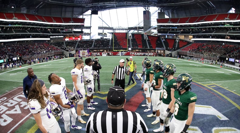 Class AAAA title game: Cartersville players (left) and Blessed Trinity players participate in the coin toss with officials before the start of the Class AAAA State Championship game at Mercedes-Benz Stadium Wednesday, December 12, 2018, in Atlanta. (Jason Getz/Special to the AJC)