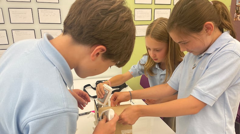 With glue, tape and dexterity, The Lovett School students assemble a prototype birdhouse as part of a design and engineering class.