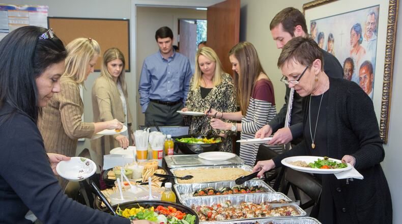 Supreme Lending employees gathered for lunch in 2017 to celebrate the month's closings.