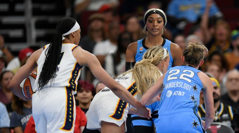 Chicago Sky's DiJonai Carrington, back, stares down Indiana Fever's Sophie Cunningham (8) after committing a flagrant foul against Cunningham and before she was ejected from the game during the first half of an WNBA basketball game in Chicago, Saturday, Aug. 8, 2026. (AP Photo/Paul Beaty)