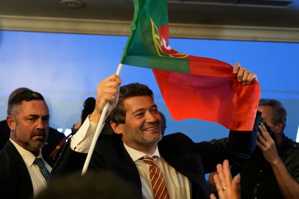 "The hard-right populist party Chega" leader Andre Ventura holds a Portugal's flag following Portugal's general election, in Lisbon, Monday, May 19, 2025. (AP Photo/Ana Brigida)