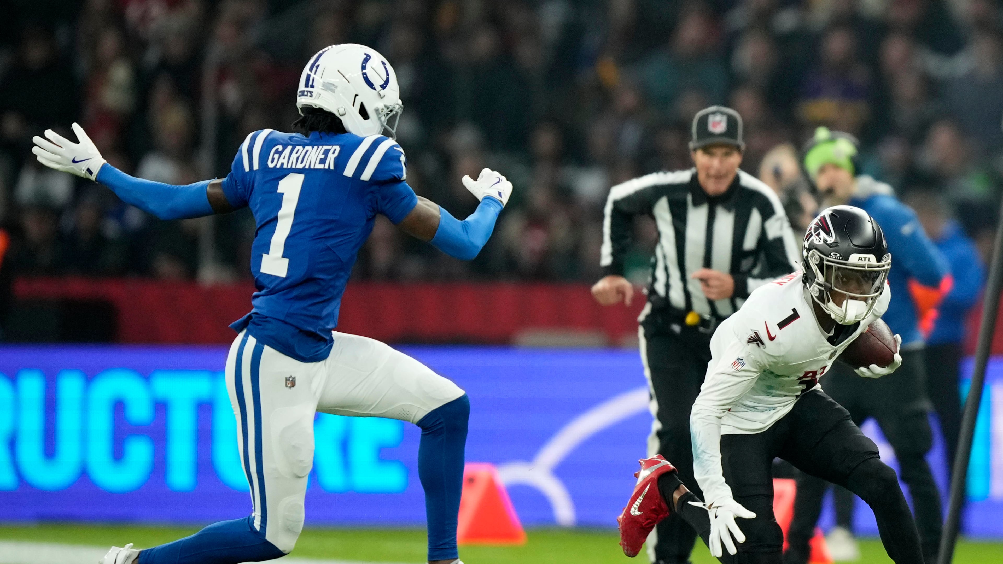 Atlanta Falcons wide receiver Darnell Mooney, right, runs from Indianapolis Colts cornerback Sauce Gardner during the first half of an NFL football game, Sunday, Nov. 9, 2025, in Berlin, Germany. (AP Photo/Ebrahim Noorozi)