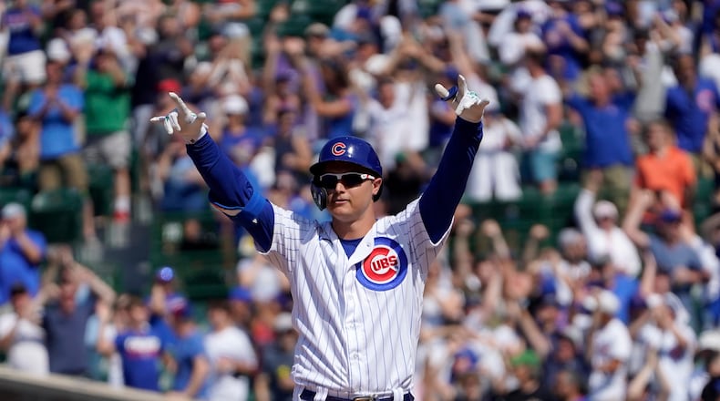 Chicago Cubs' Joc Pederson looks around Wrigley Field and celebrates his two-run double off St. Louis Cardinals relief pitcher Genesis Cabrera during the seventh inning of a baseball game Friday, June 11, 2021, in Chicago. (AP Photo/Charles Rex Arbogast)