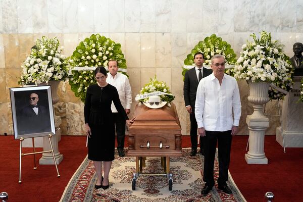 Dominican Republic President Luis Abinader, front right ands his wife Raquel Arbaje Soni, front left, attend the wake of Dominican singer Rubby Perez who died in the roof collapse at the Jet Set nightclub during his merengue concert, at the Eduardo Brito National Theater in Santo Domingo, Dominican Republic, Thursday, April 10, 2025. (AP Photo/Matias Delacroix)