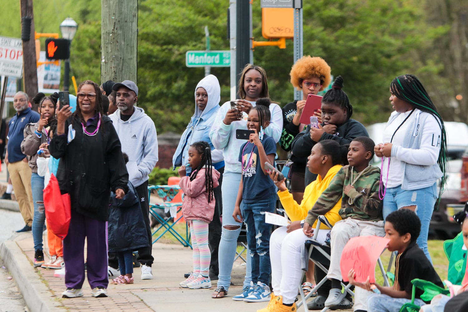 Members of the community watch and take videos during the Atlanta Public School parade on Saturday, April 22, 2023. The parade celebrated the 150th anniversary of Atlanta Public Schools and featured students, teachers and other members of the APS community. CHRISTINA MATACOTTA FOR THE ATLANTA JOURNAL-CONSTITUTION