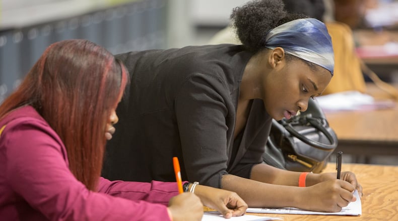Applicants fill out forms during a job fair hosted by Hartsfield-Jackson with more than 1,000 positions up for grabs. Officials said many of the opportunities will be part of ATLNext, the airport’s multibillion-dollar capital improvement program. (Photo by Phil Skinner)