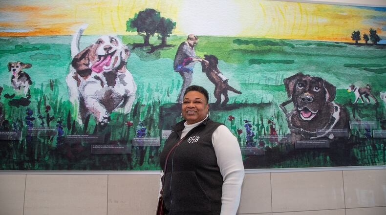 Portrait of Rita Harris who are featured, with her guide dog Madden, in the mural behind them in Course F at Hartsfield-Jackson International Airport. Harris is a blind women living in Madison who started a nonprofit to help others who are vision impaired. The organization is called Living Life Team.
PHIL SKINNER FOR THE ATLANTA JOURNAL-CONSTITUTION.