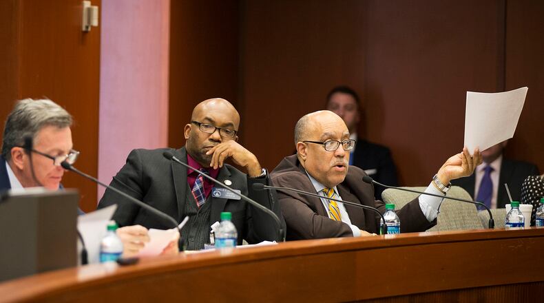 Georgia Sen. Vincent Fort, D-Atlanta, holds up a document as Senate committee members debate a measure that would permit those with concealed carry weapons licenses to bring their guns onto public college campuses Monday, March 7, 2016, in Atlanta. The Senate committee's approval on Monday brings Georgia lawmakers one step closer to passing the bill, which could reach the Senate floor this week. (AP Photo/David Goldman)