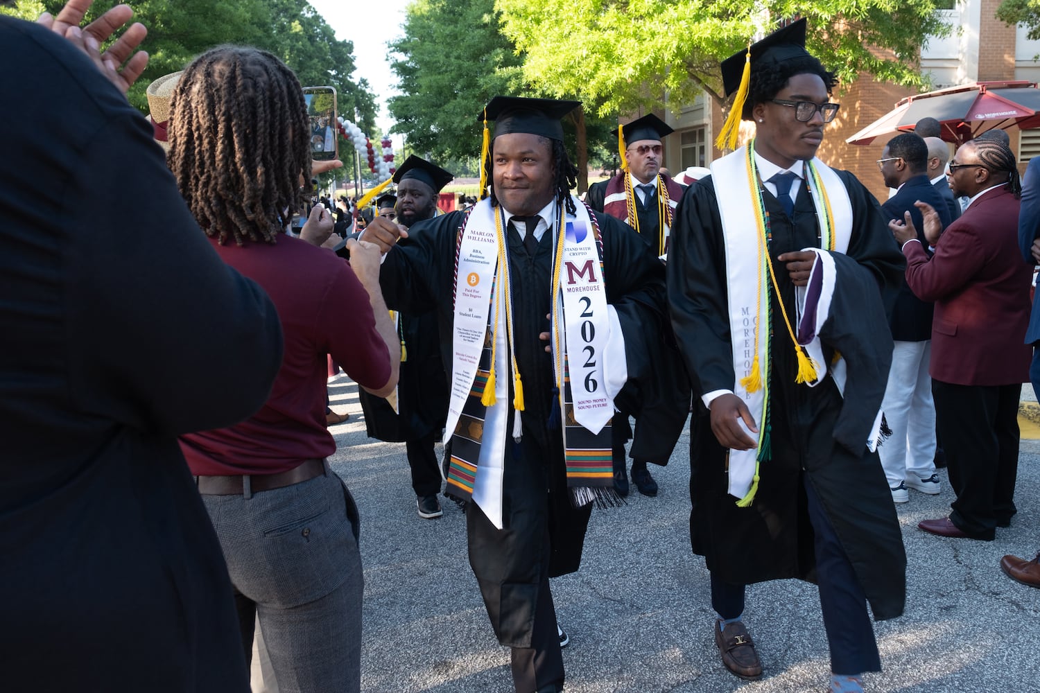 Graduates make their way down the alumni corridor on their way to Morehouse College commencement Sunday, May 17, 2026. (Ben Gray for the AJC)