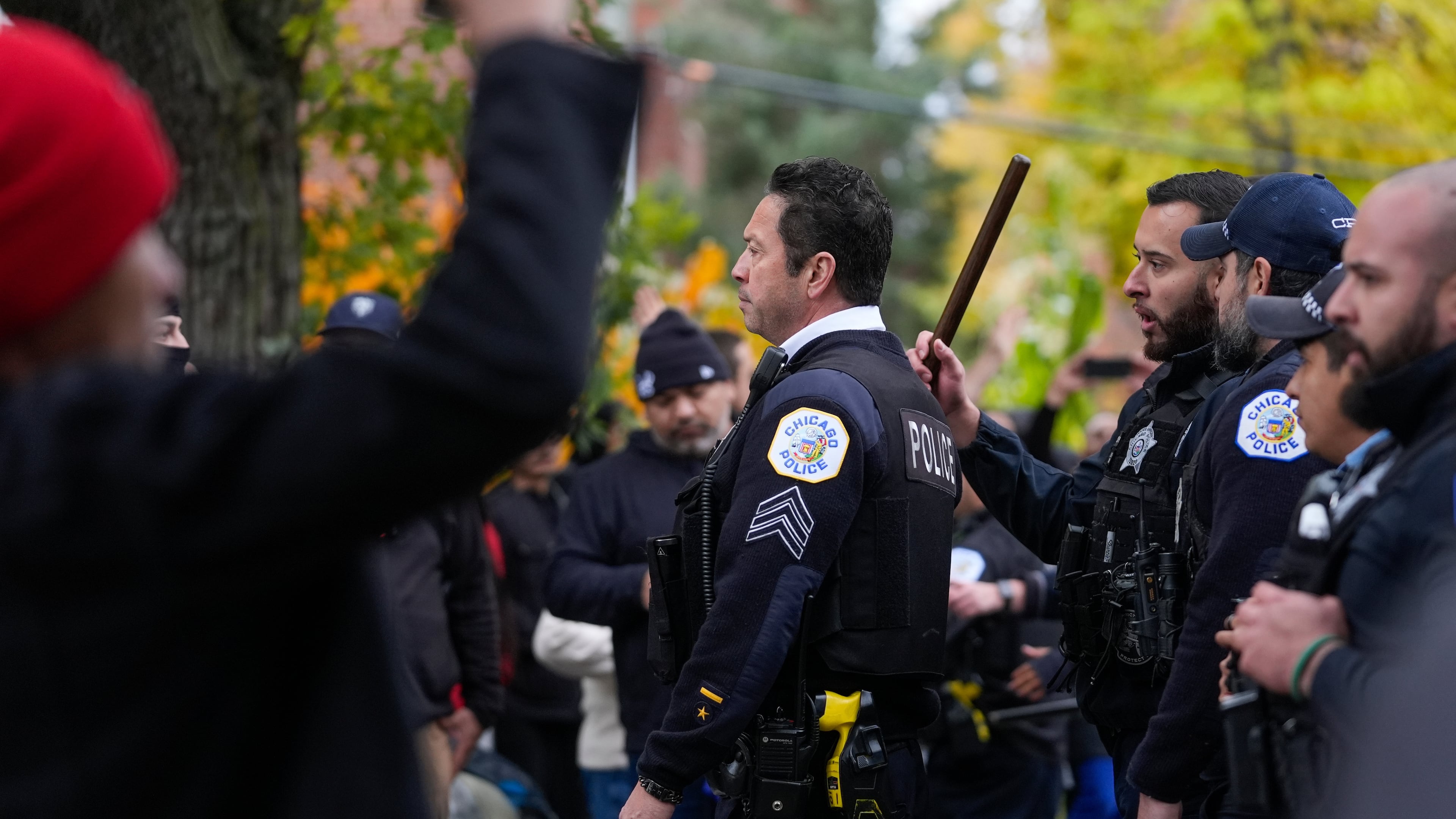 People protesting the actions of federal immigration agents in Little Village clash with Chicago police officers Saturday, Nov. 8, 2025, in Chicago. (AP Photo/Erin Hooley)