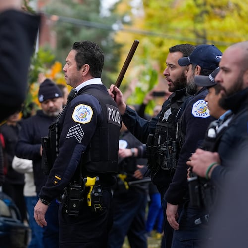People protesting the actions of federal immigration agents in Little Village clash with Chicago police officers Saturday, Nov. 8, 2025, in Chicago. (AP Photo/Erin Hooley)