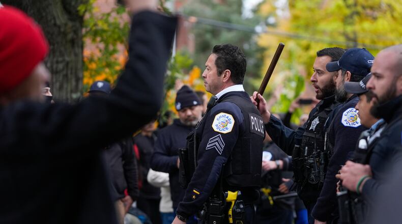 People protesting the actions of federal immigration agents in Little Village clash with Chicago police officers Saturday, Nov. 8, 2025, in Chicago. (AP Photo/Erin Hooley)