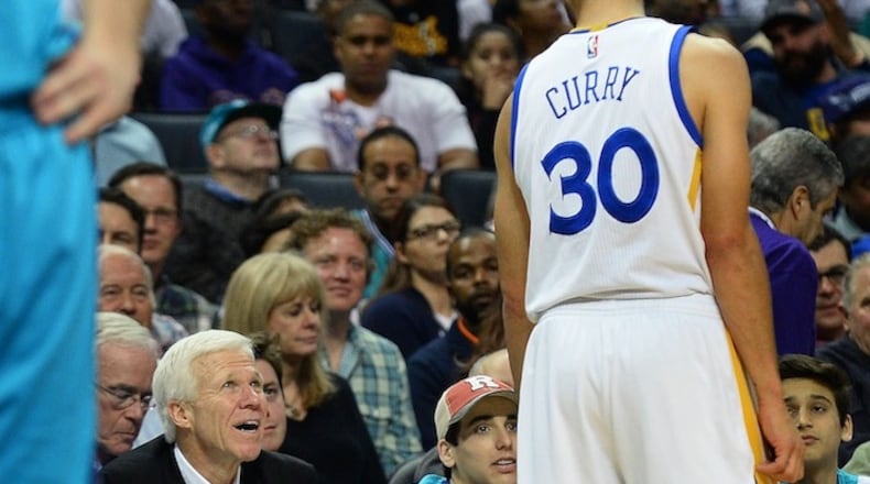 The Golden State Warriors' Steph Curry (30) talks with Davidson College coach Bob McKillop, left, during a break in action against the Charlotte Hornets at the Spectrum Center in Charlotte, N.C., on Wednesday, Jan. 25, 2017. (Jeff Siner/Charlotte Observer/TNS)