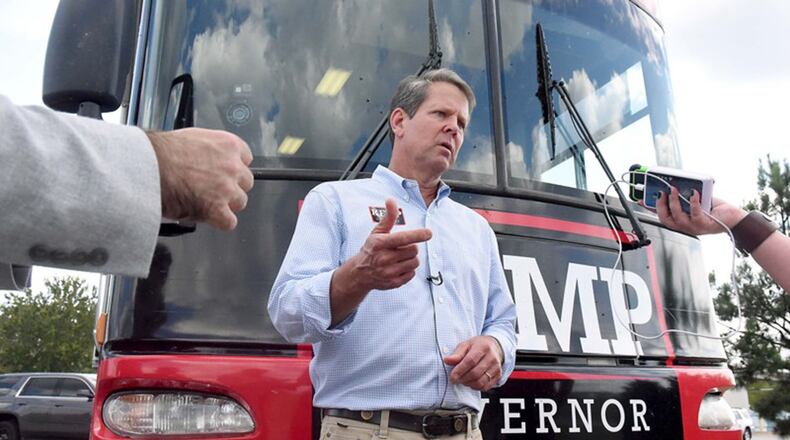 GOP candidate for governor Brian Kemp takes questions from reporters in front of the Kemp campaign bus, after speaking to supporters in Perry. Kemp’s campaign style hasn’t relied on celebrity appearances but plays up his rural roots.