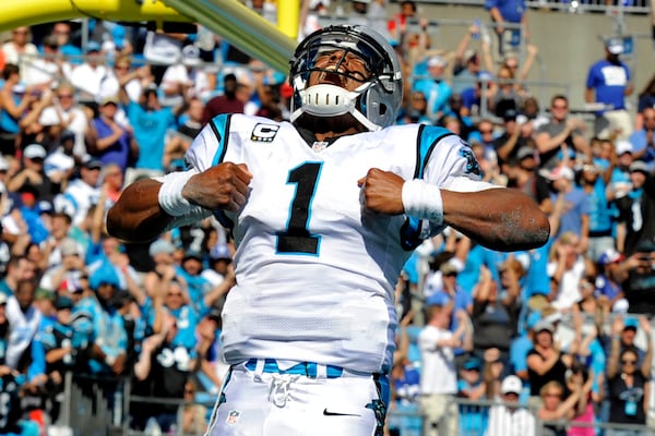  Carolina quarterback Cam Newton celebrating after scoring a touchdown against the New York Giants last December. (Associated Press)