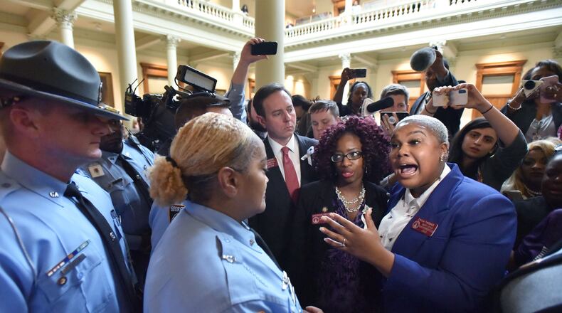 State Rep. Erica Thomas shouts out as Georgia state troopers try to disperse anti-abortion demonstrators after House Bill 481, an anti-abortion “heartbeat bill,” passed on Friday. The Georgia House narrowly voted 92-78, one vote more than needed, to approve legislation that would outlaw most abortions at about six weeks into a pregnancy. HYOSUB SHIN / HSHIN@AJC.COM