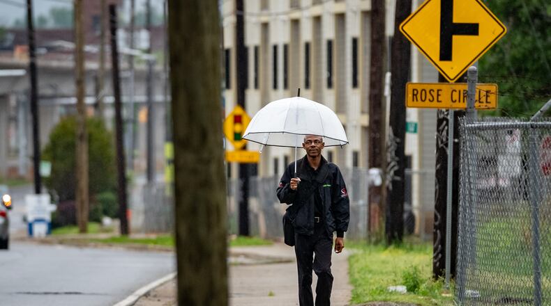 A man walks in the rain along Lee Street in Atlanta on April 7, 2025. Monday's forecast calls for more rain. (Ben Hendren for the AJC)