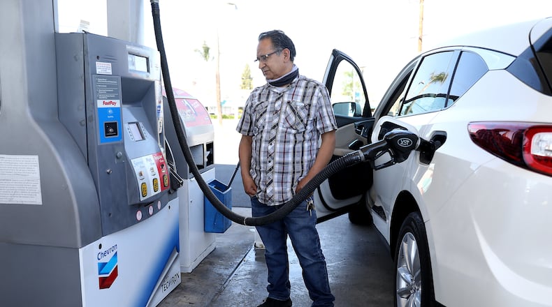 Juan Galaiviz of Santa Ana, California, pumps gas into his automobile at a Chevron gas station on March 8, 2022. Galaiviz paid $50.00 for 8.866 gallons of regular gasoline. (Gary Coronado/Los Angeles Times/TNS)