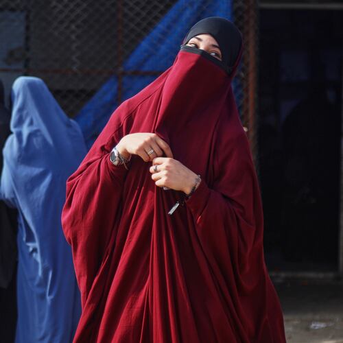 Women wait to enter a building supplying food and other goods at Roj camp, one of the detention facilities holding thousands of Islamic State group members and their families, in the al-Malikiyah area of northeastern Syria, Thursday, Jan. 29, 2026. (AP Photo/Baderkhan Ahmad)
