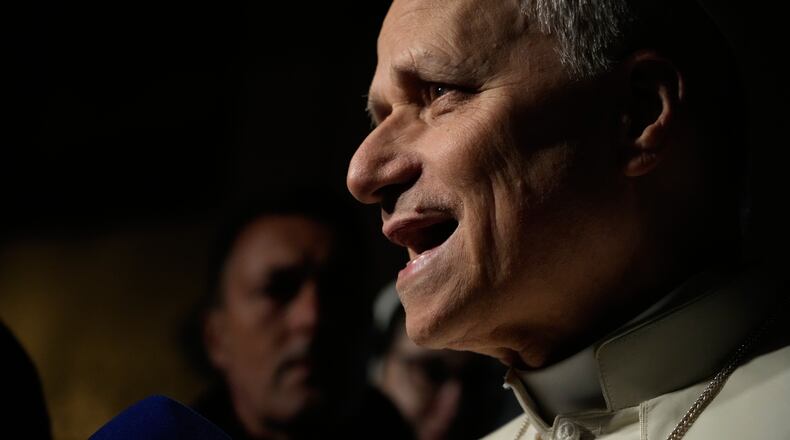 Pope Leo XIV talks to journalists as he leaves his residence in Castel Gandolfo, on the outskirts of Rome, to return to the Vatican, Tuesday, March 31, 2026. (AP Photo/Gregorio Borgia)